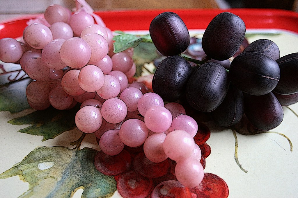 Vintage plastic grapes on a vintage food tray, used here for illustration purposes only.