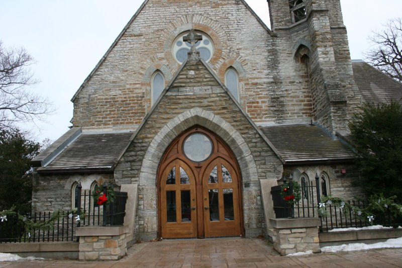 The arched wooden front doors present an impressive entry.