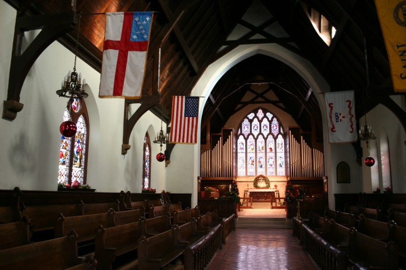 Inside the historic sanctuary, the pews face the aisle rather than the altar.