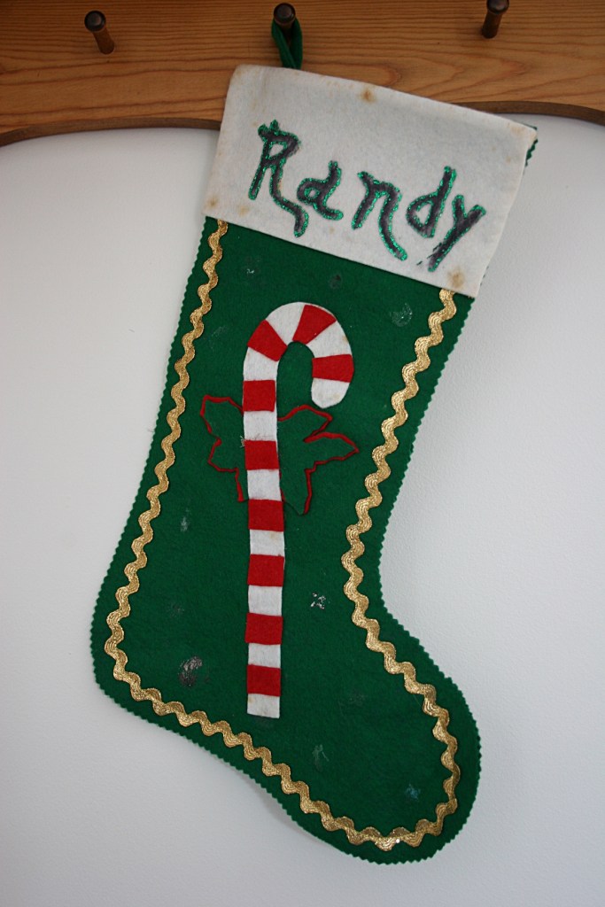 I did not grow up with Christmas stockings. But my husband did. Randy's aunt made this stocking for him in the 1960s. It's missing a few decorations. But that adds to its character.