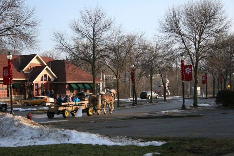 Free horse-drawn wagon rides were offered around downtown Faribault Saturday afternoon. Here the wagon, with Santa aboard, passes The Depot Bar and Grill.