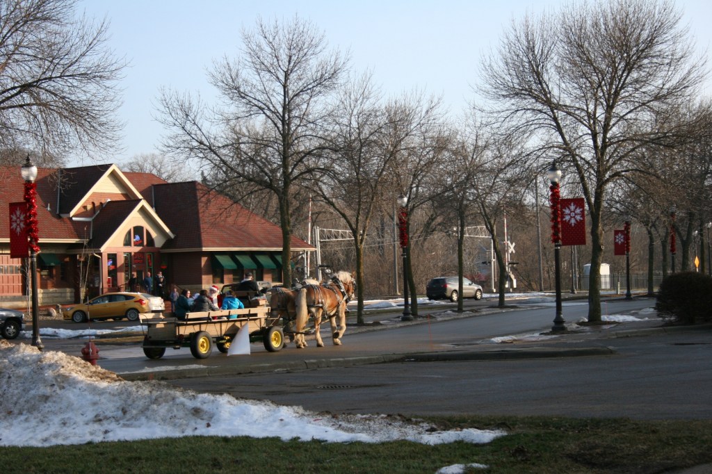 Free horse-drawn wagon rides were offered around downtown Faribault Saturday afternoon. Here the wagon, with Santa aboard, passes The Depot Bar and Grill.