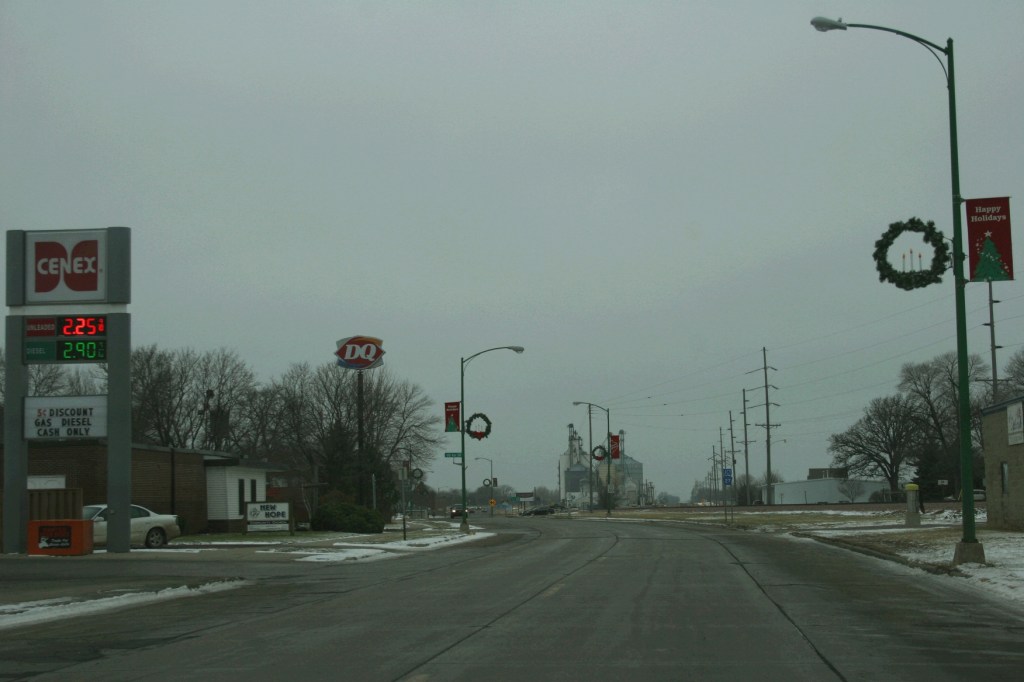 U.S. Highway 14 curves toward grain bins on the west edge of Sleepy Eye.