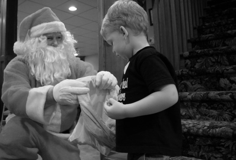 My great nephew, Hank, age 2 1/2, picks candy from Santa's bag at the Kletscher family Christmas.
