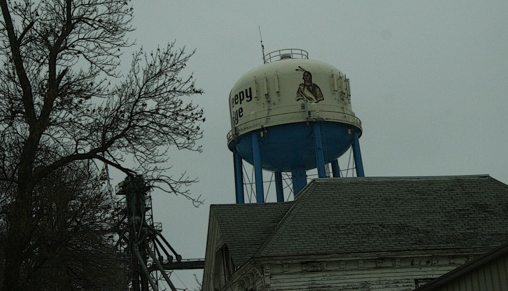 A passing shot shows Chief Sleepy Eye's image painted on the water tower.