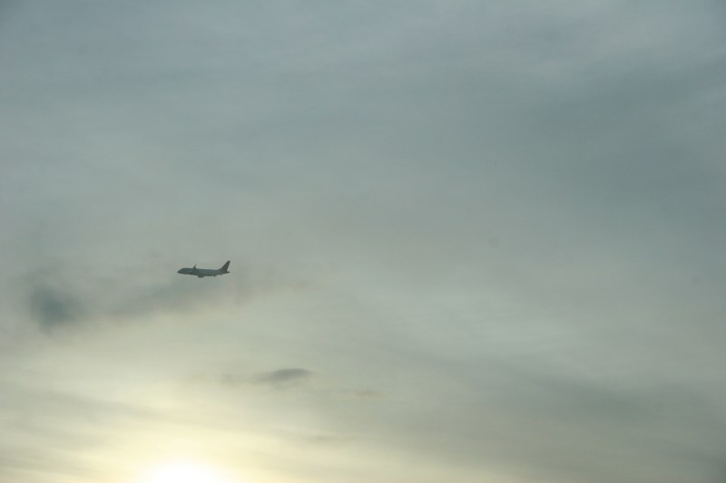 A plane flies out of the Minneapolis-St. Paul International Airport.