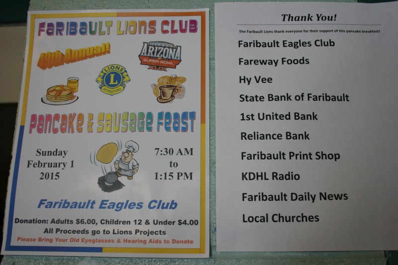 Signs advertise the event and thank sponsors.