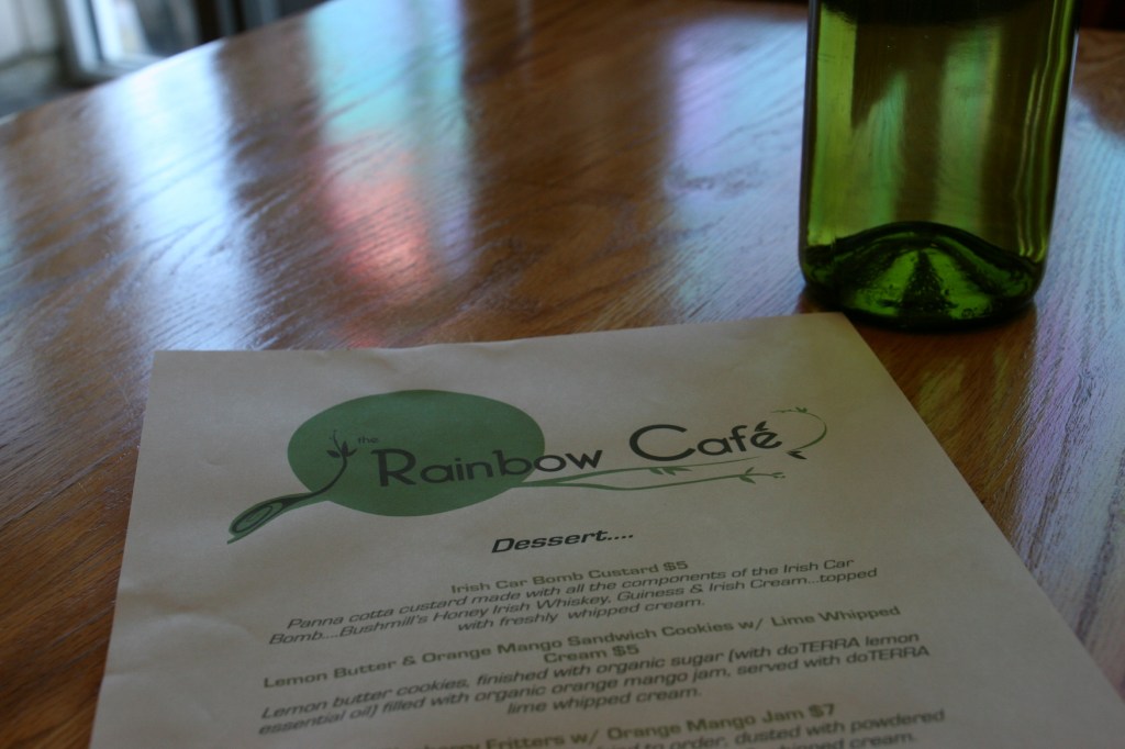 The dessert menu and water served in a wine bottle.