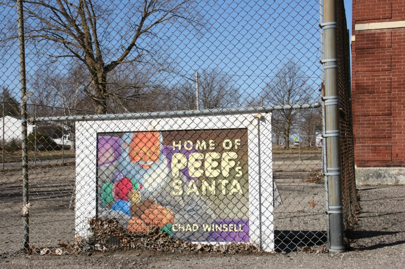 This sign shows the artwork for the first PEEF book's cover with local Chad Winsell as the Santa model.