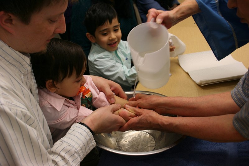 Participants had their hands washed by volunteers just as Christ washed his disciples' feet .