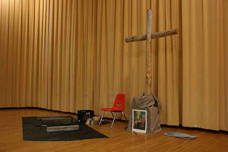 The stage was set with a cross, hammer and nails. Participants pounded nails into wood. Christ was nailed to the cross.