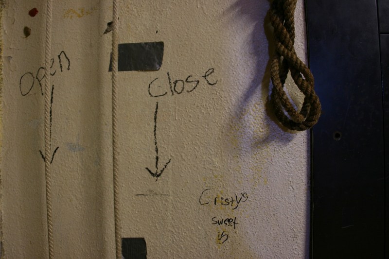 Instructions on the stage wall for operating the curtain.