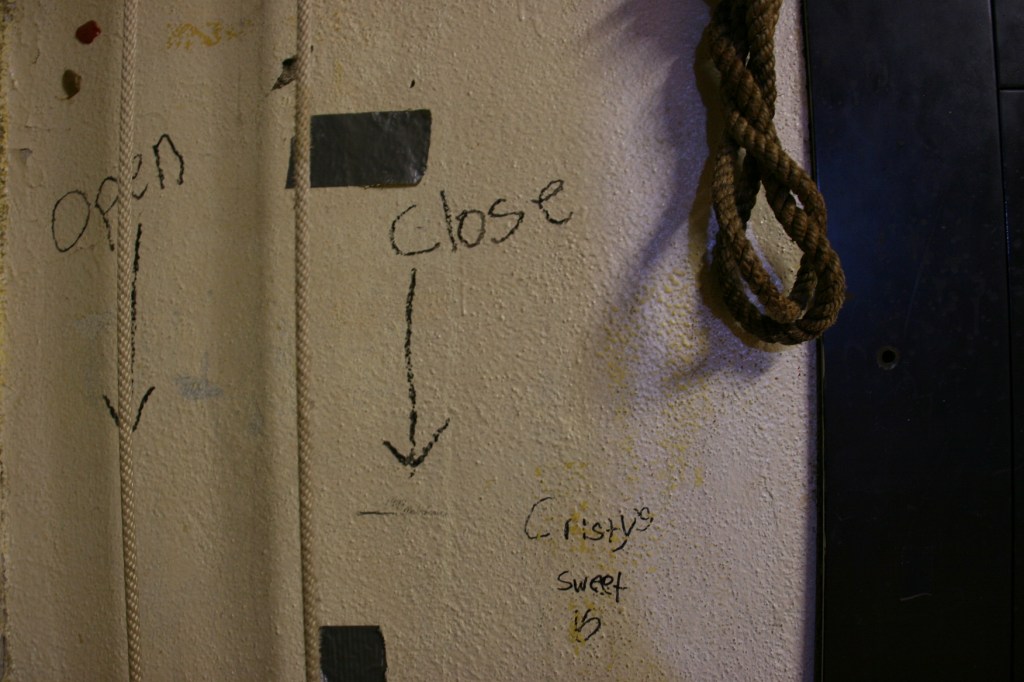 Instructions on the stage wall for operating the curtain.