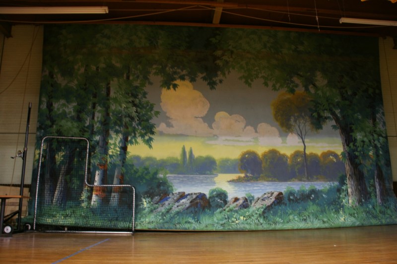 This massive WPA project painting hangs as a stage backdrop.