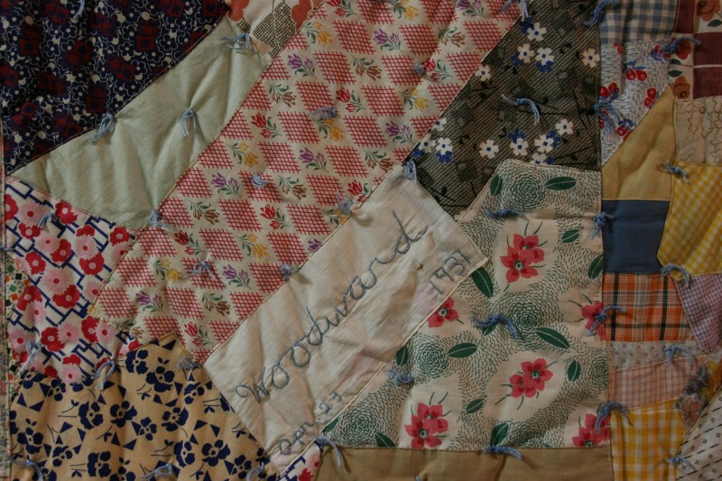 Beautiful handmade quilts are displayed.