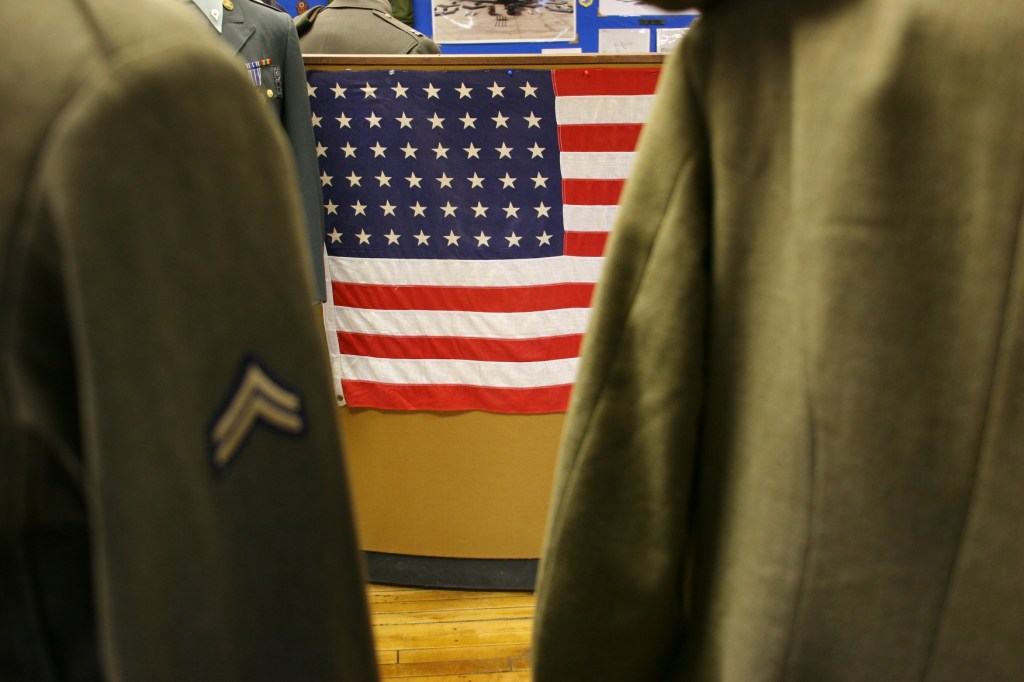 Between two military uniforms, I shot this view of a 48-star American flag.