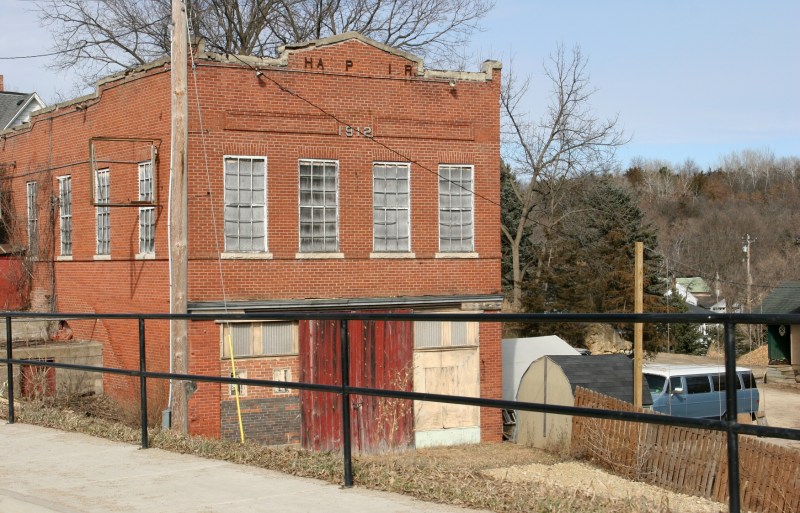A boarded up building dated 1912.