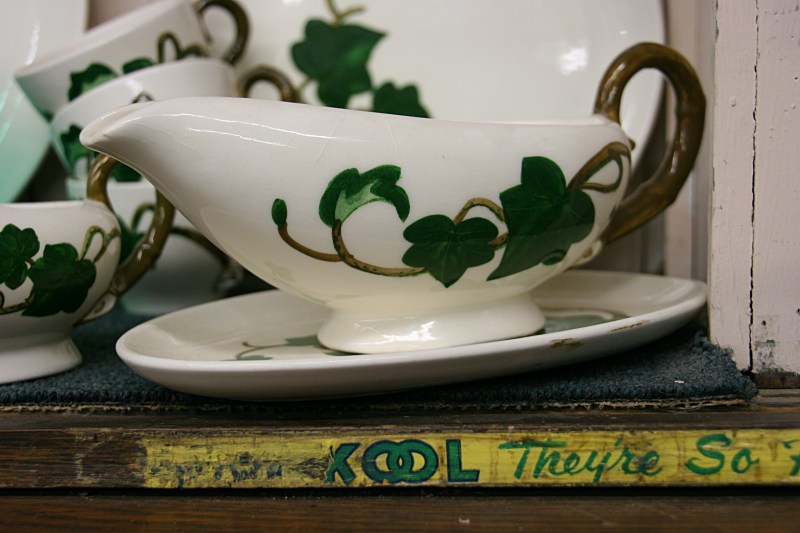 I was as much drawn to the art on the gravy bowl as to the writing on the edge of the aged shelving.