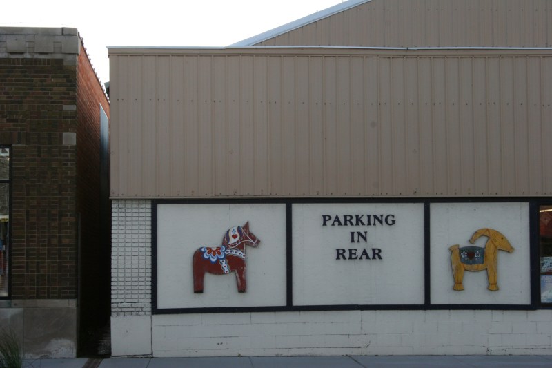A Swedish dala horse and  Yule goat posted on a business honor this community's Swedish heritage.