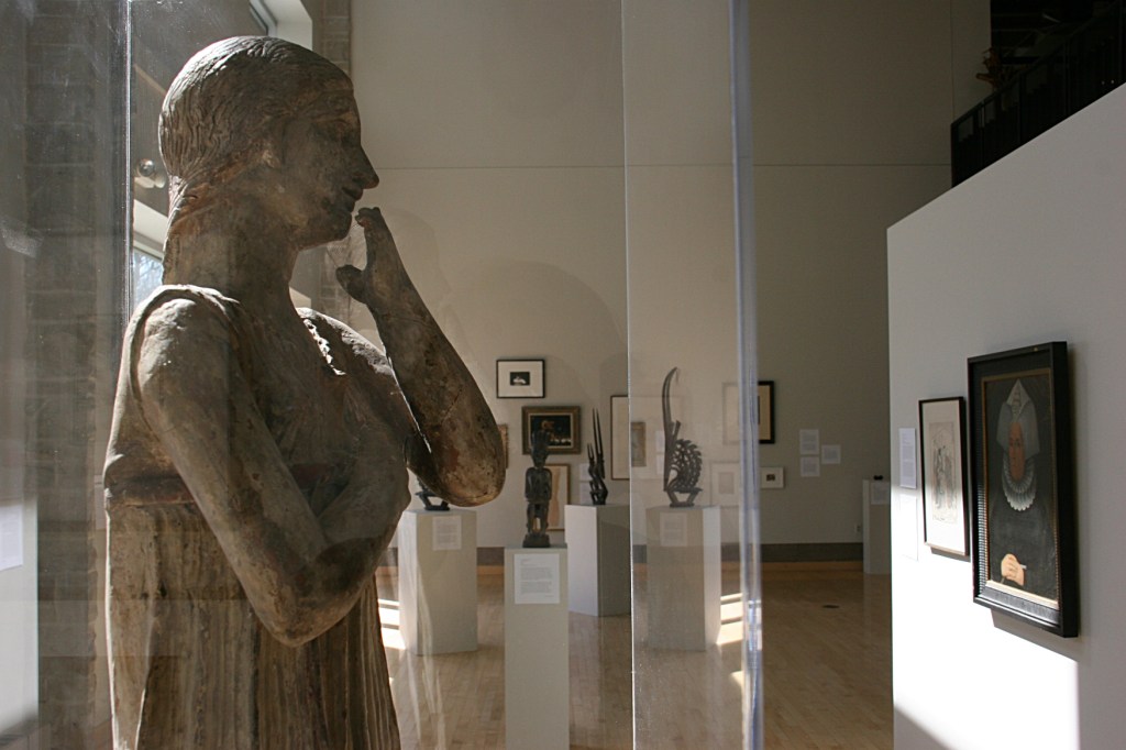 The angle at which I photographed "Archaic Greek Statue of a Woman" makes it appear as if the Italian terra cotta sculpture is studying the art on display.