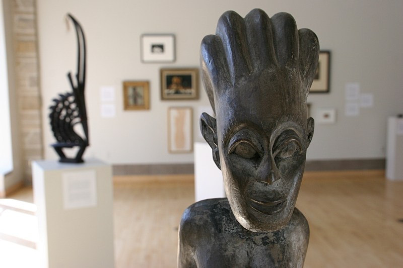 A wood sculpture from Africa, artist unknown, and titled "Seated Maternity Figure."