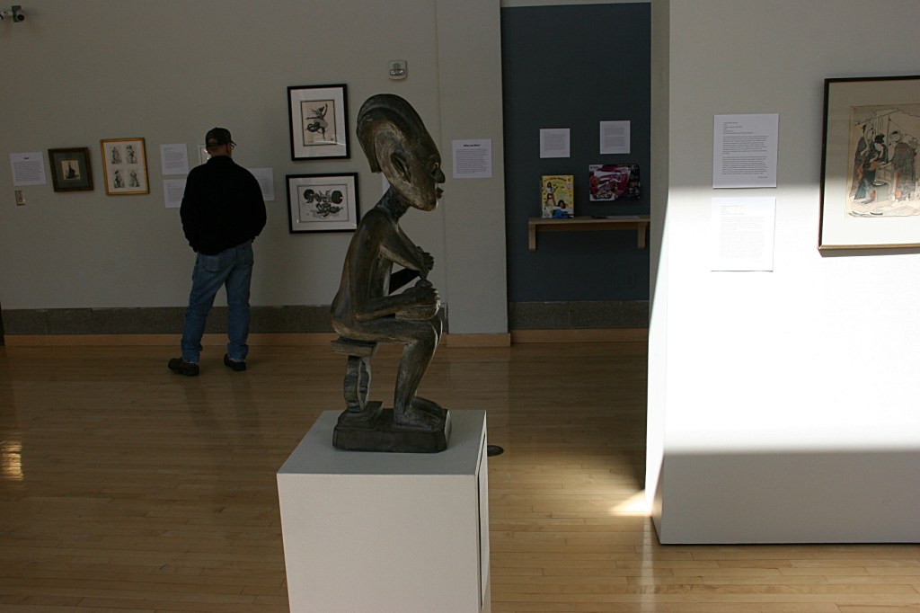 My husband peruses the art.