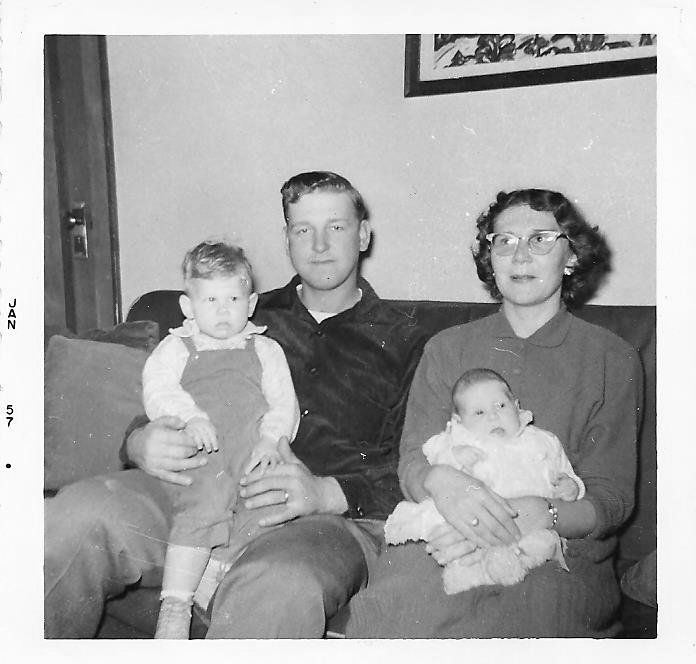 The only photo I have of my mom holding me. My dad is holding my brother Doug.