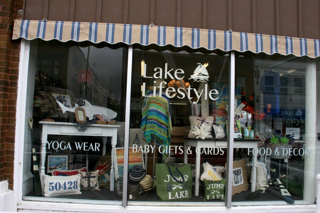 Creative window displays draw shoppers into businesses like Lake Lifestyle.