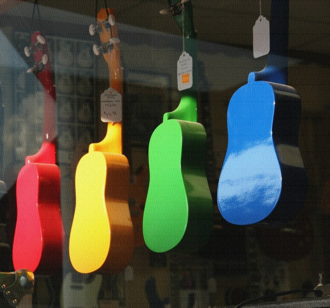 A row of vibrant ukuleles are suspended in the front window of Eastman Music in historic downtown Faribault, Minnesota.