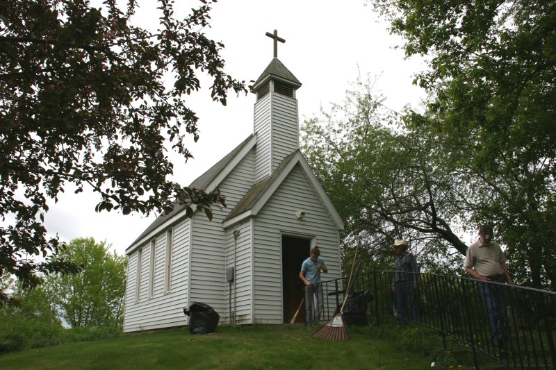 My husband, Randy, leaves the Guardian Angel Roadside Chapel as Scott Kennedy and his nephew finish cleaning.