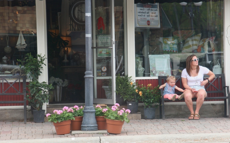 Relaxing outside a Clear Lake floral and gift shop, The Red Geranium.