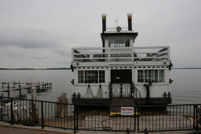 A couple was fishing right next to the tethered cruise boat.