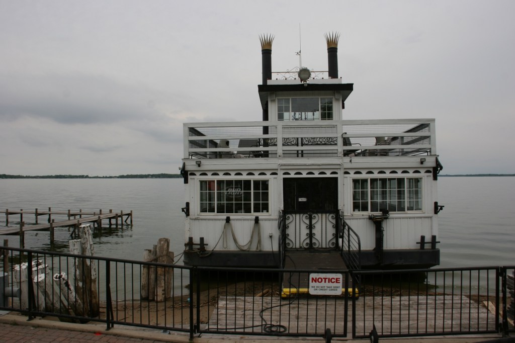 A couple was fishing right next to the tethered cruise boat.