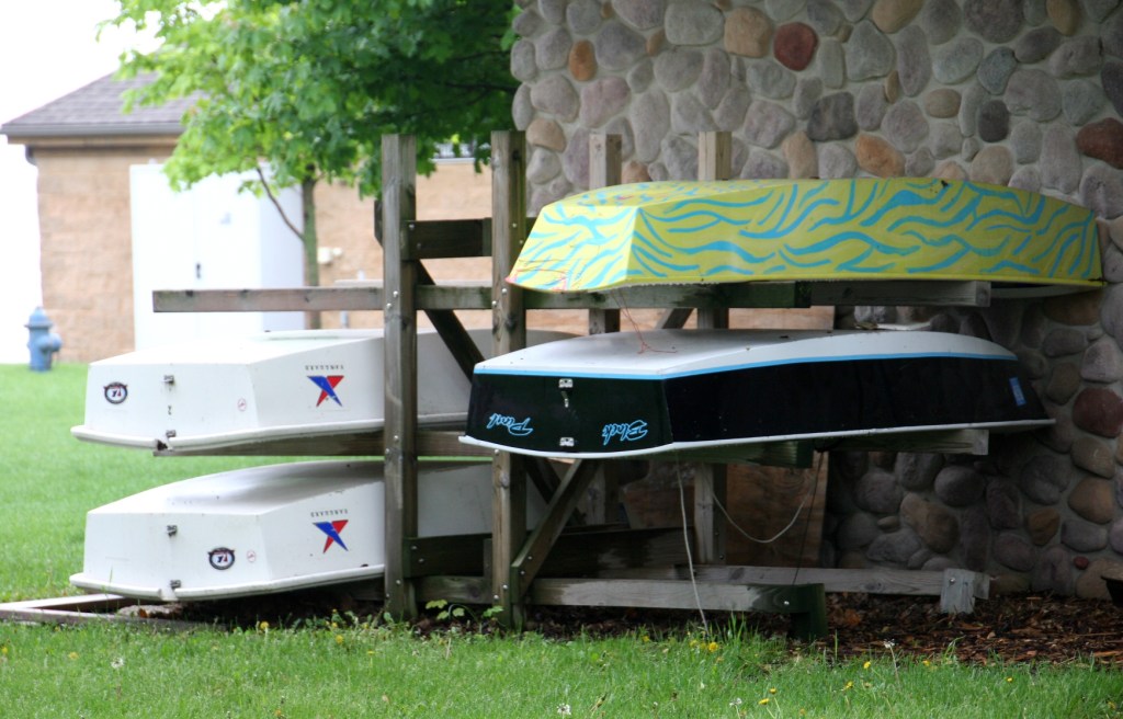 Boats stacked behind the Clear Lake Yacht Club next to the public access.