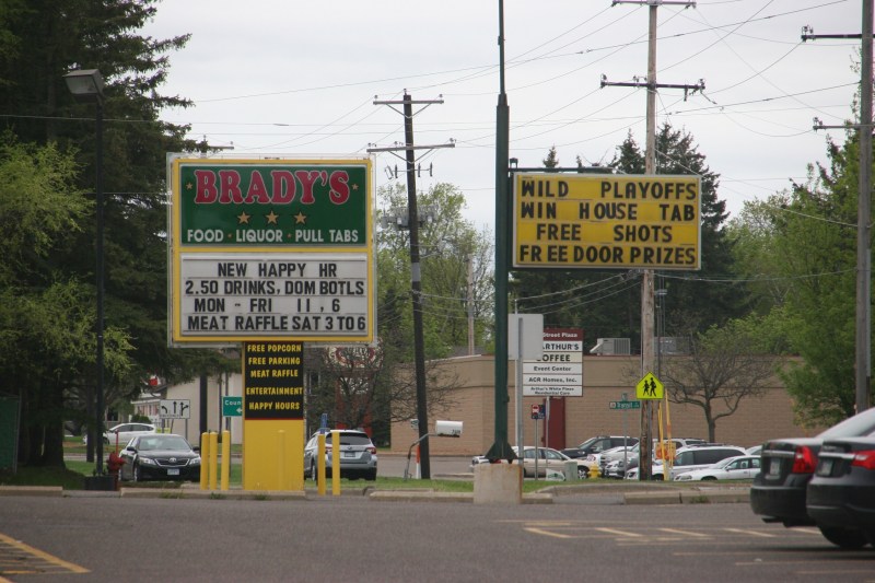 Then I turned to the right to photograph these roadside messages posted to draw customers into Brady's a "local bar with great service and a wonderful fun filled atmosphere."