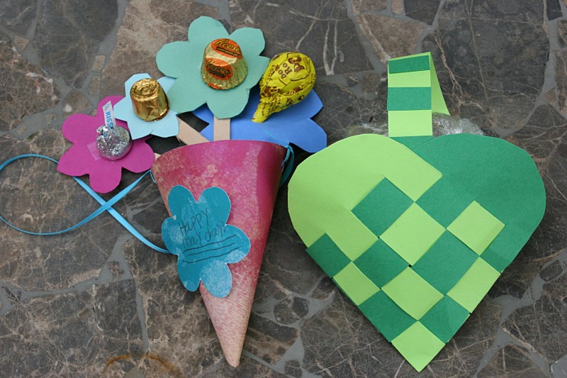 The two May Day baskets dropped on my front steps this morning. The one on the right reminds me of the baskets I wove as a child for my mother.