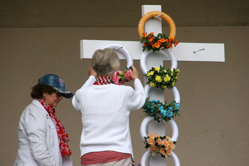As is tradition each year, members of American Legion Auxiliary Unit 43 place wreaths on the memorial cross.