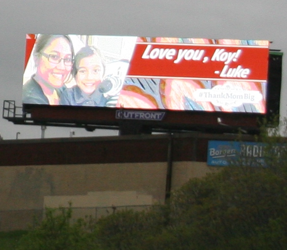 A personalized Mother's Day message on a billboard momentarily distracts me.