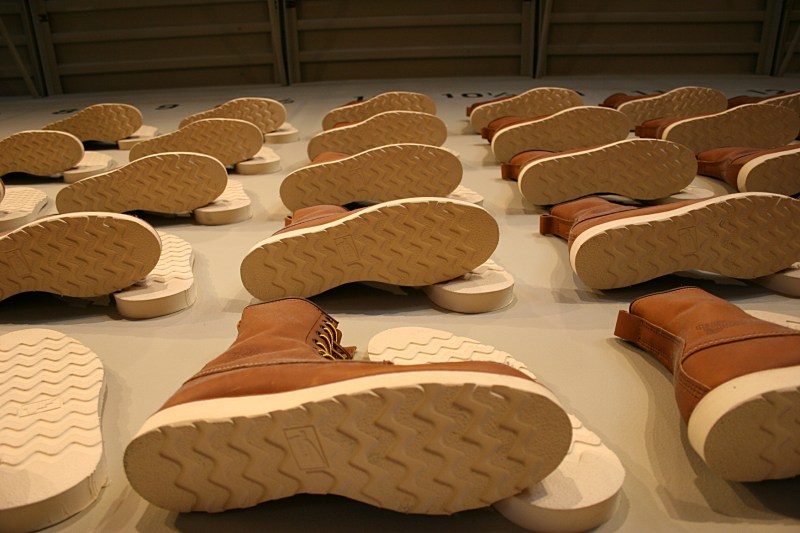 Rows of boots line a wall leading to the second floor museum.