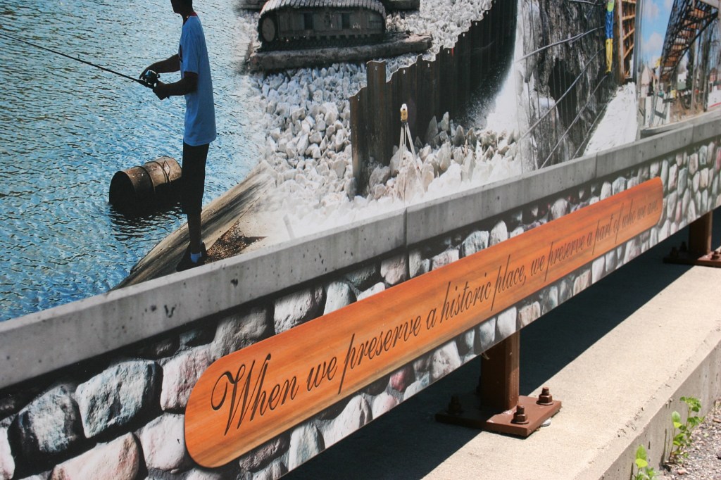 A sign next to the bridge reads: "When we preserve a historic place, we preserve a part of who we are."