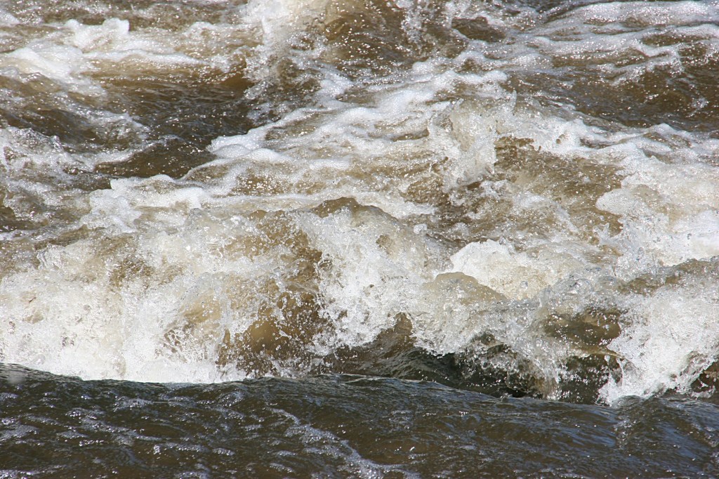 Water roars over rocks in the Straight River at Moreshouse Park.