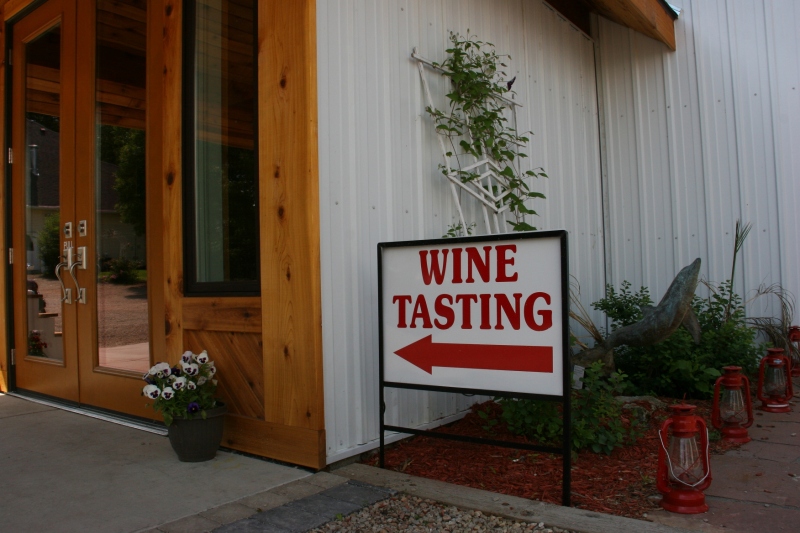 A sign directs visitors to the tasting room.