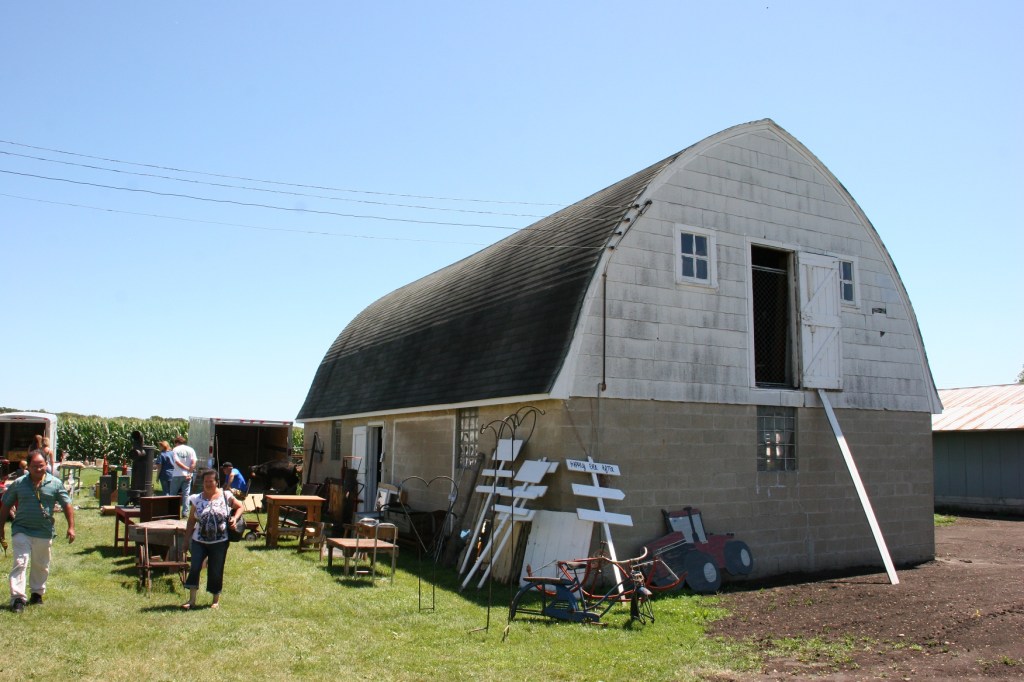 The barn is filled with goods, from lower level to hayloft.