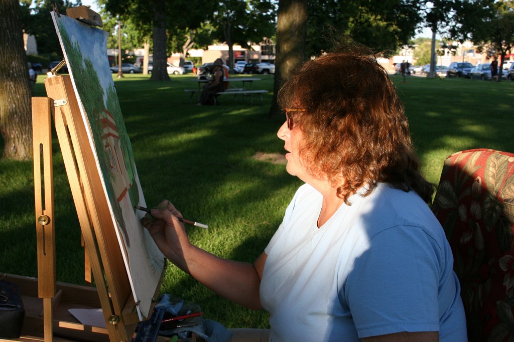 Shadows and light play on Barb Bruns as she works.