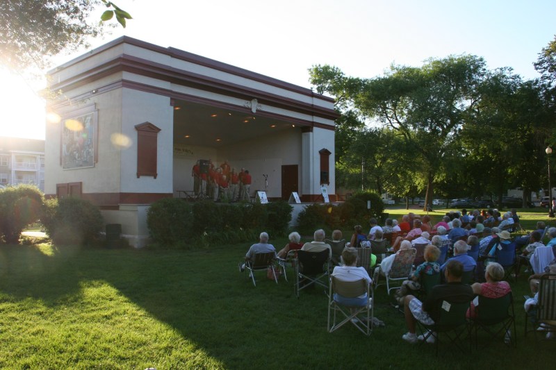 the sun sets behind the bandshell as the barbershoppers sing tunes ranging from "Sweet Caroline" to "God Bless America."
