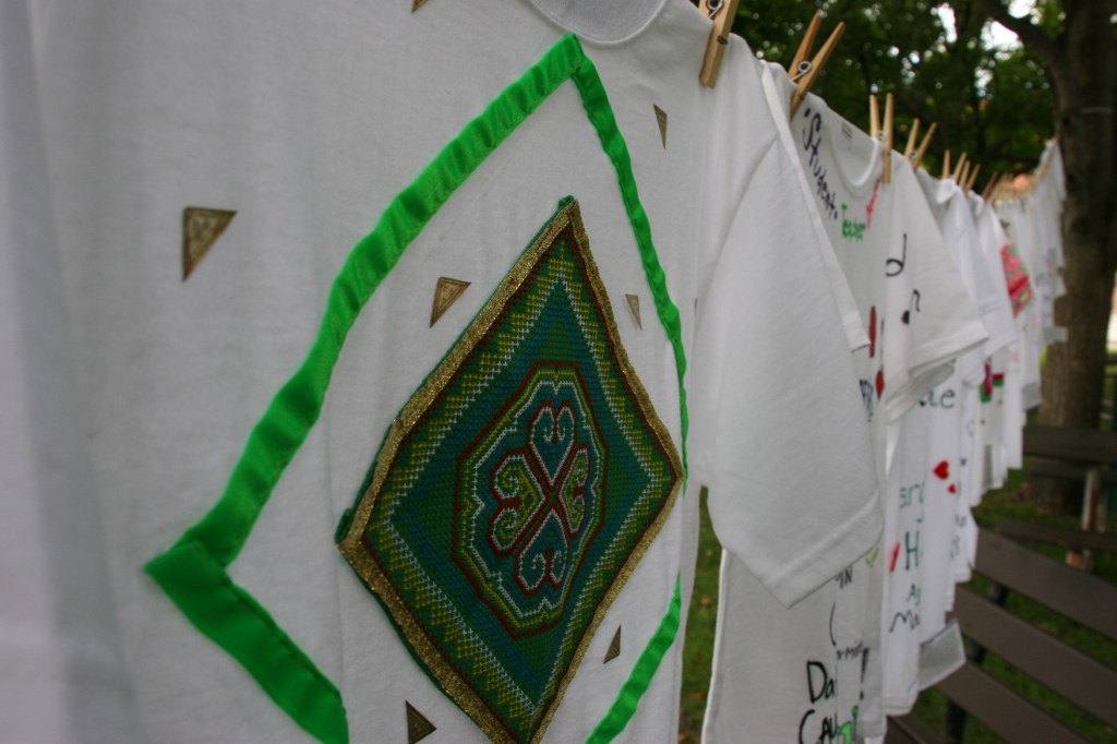 Clothesline Project, t-shirts in a row, green design