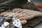 Family, brats on&nbsp;grill
