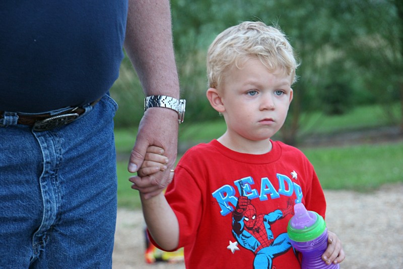 At the end of a long day, my three-year-old great nephew grips his grandpa's hand.