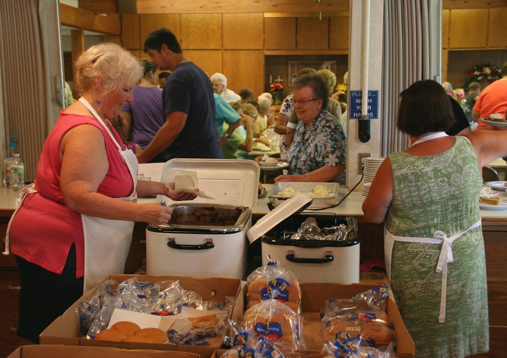 Lynn, left, and Kim, right, make sandwiches.