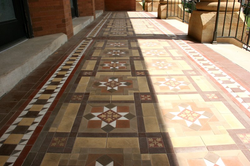 In sunlight (right) and in shade, the exterior tile floor under the columned entry is lovely.